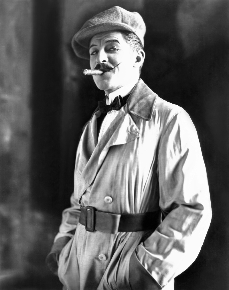 man waxed mustache cigar flat cap belted coat 1920s