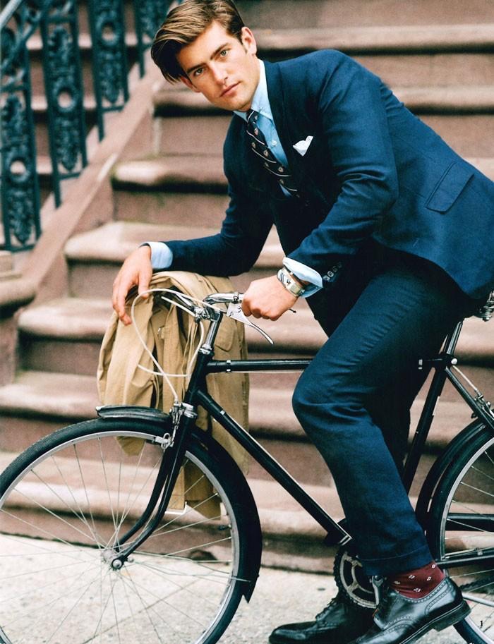 Justin Hopwood takes a bike ride in a smart Polo Ralph Lauren navy suit.