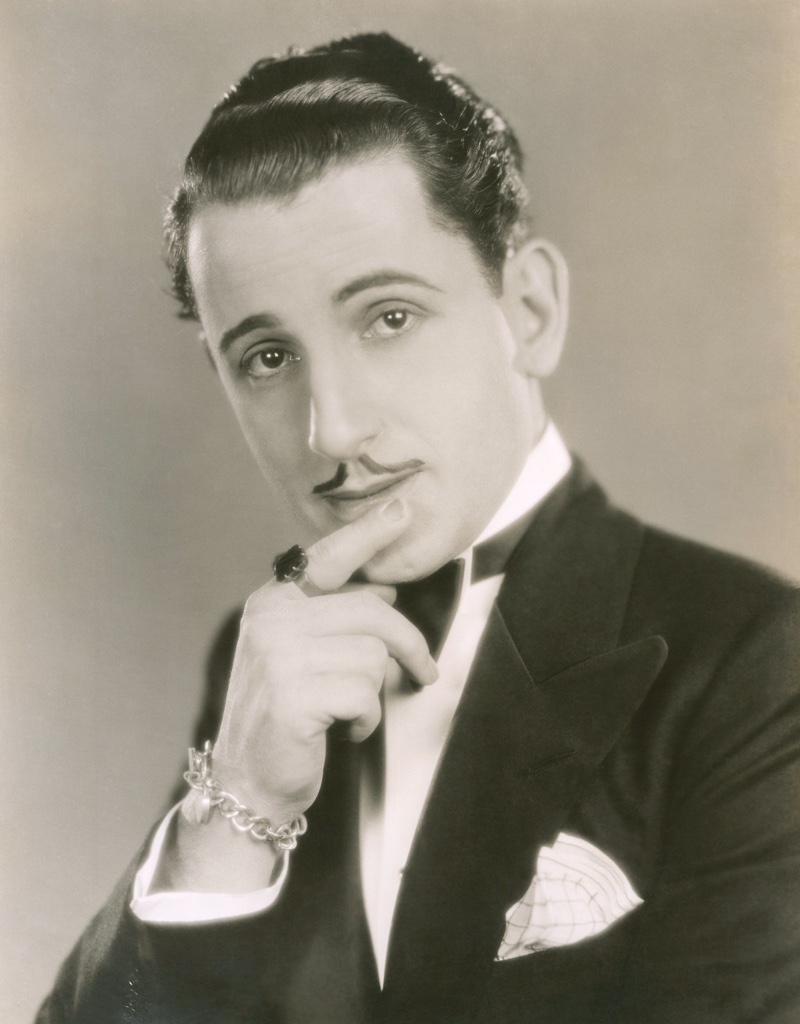 During the 1920s, men favored a clean shaven face or a small mustache. A man shows off a slicked back hairstyle with a thin mustache. 1920s Men's Hairstyles