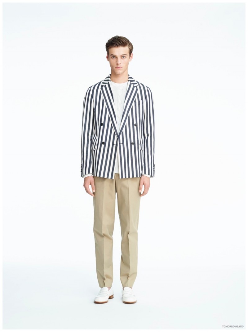 Model Robbie Wadge wears a striped Tomorrowland double-breasted blazer with slim-cut, pleated khaki trousers.