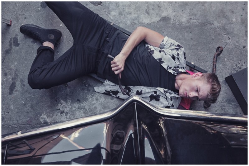 Noah Teicher prepares to get his hands dirty in a lean black ensemble with a trendy short-sleeve printed shirt.