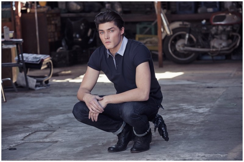 A classic vision in blue, Isaac Weber rocks dark rinse denim jeans with a navy polo shirt.