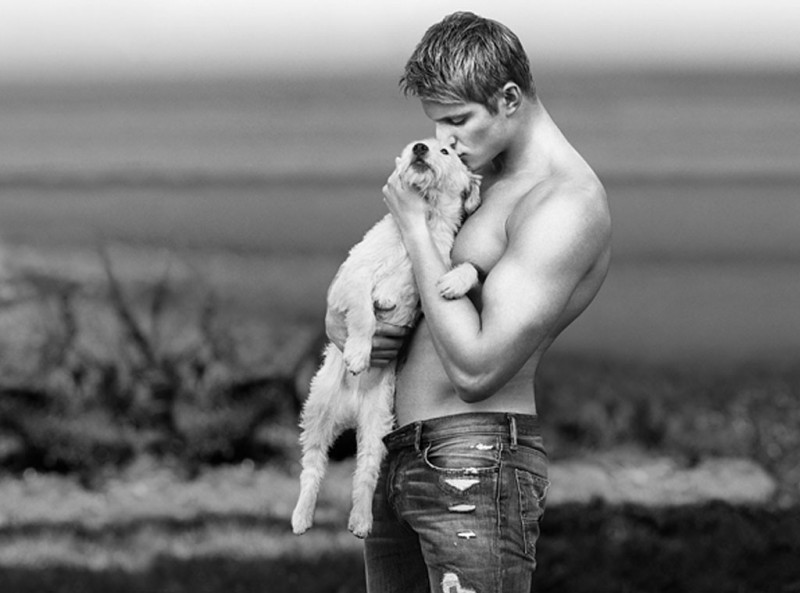 Vikings actor Alexander Ludwig poses outdoors shirtless with a dog for a 2013 Abercrombie & Fitch actor feature.