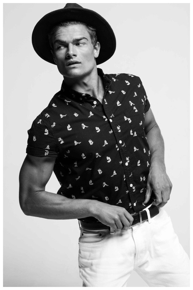 Aidan Anderson sports a printed short-sleeve shirt with a trendy hat.