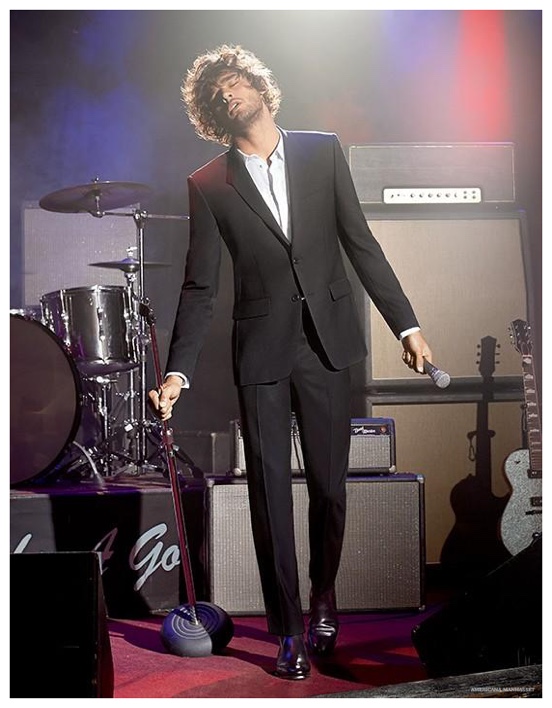 Marlon Teixeira takes the stage in a slim black suit.