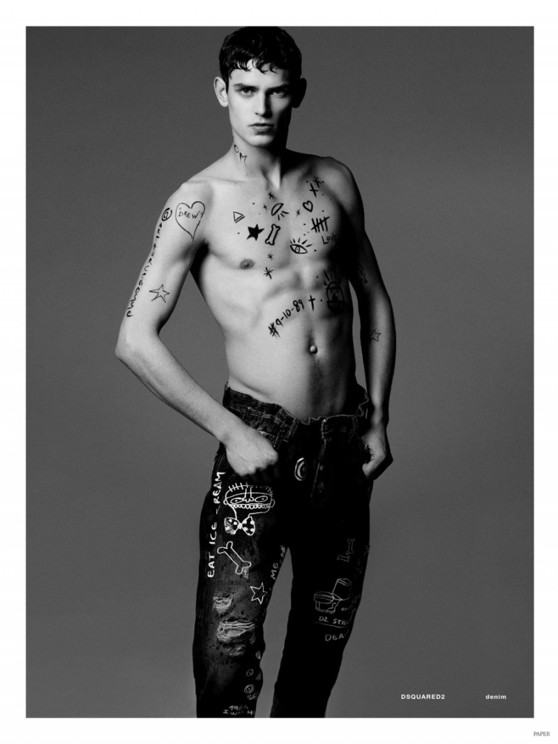 The writings on Arthur Gosse as he wears graffiti denim jeans from Dsquared2. 