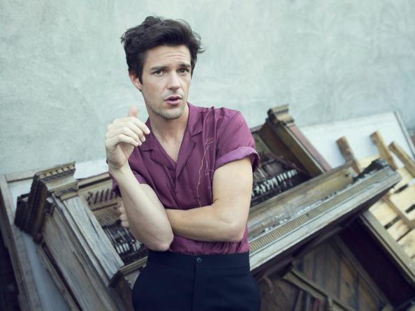 Wearing a short-sleeve retro inspired shirt, Brandon Flowers poses for InStyle.