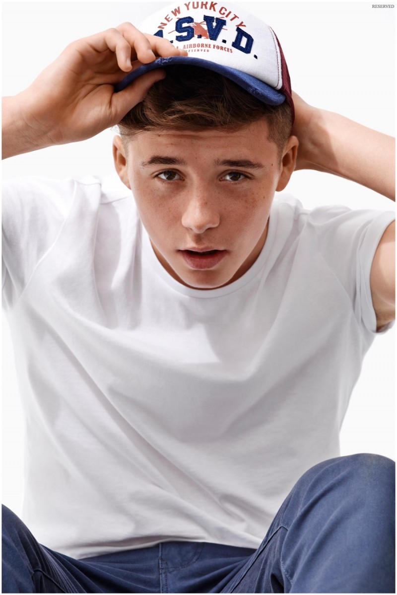 Brooklyn Beckham keeps it simple in a t-shirt and cap.