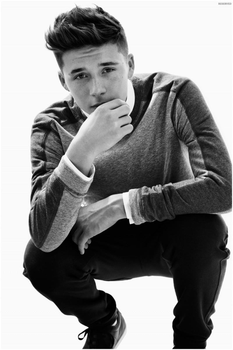 Brooklyn Beckham models a trendy sweatshirt.