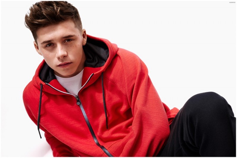 Brooklyn Beckham gets sporty in a red hooded top.