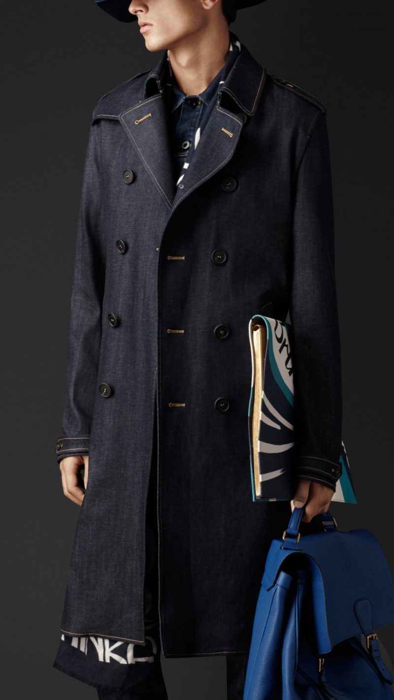 Burberry Prorsum Spring/Summer 2015: Christopher Bailey revisits Burberry's iconic trench coat for spring with trendy denim treatment. The essential trench is furnished in raw denim for a unique take on the classic. Available on Burberry.com.
