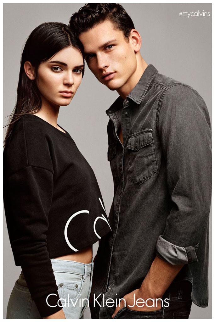 Wearing a denim shirt, Simon Nessman poses with Kendall Jenner for Calvin Klein Jeans.
