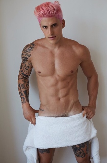 Rocking pink hair, Brazilian model Danilo Borgato poses for Mario Testino's Towel Series.