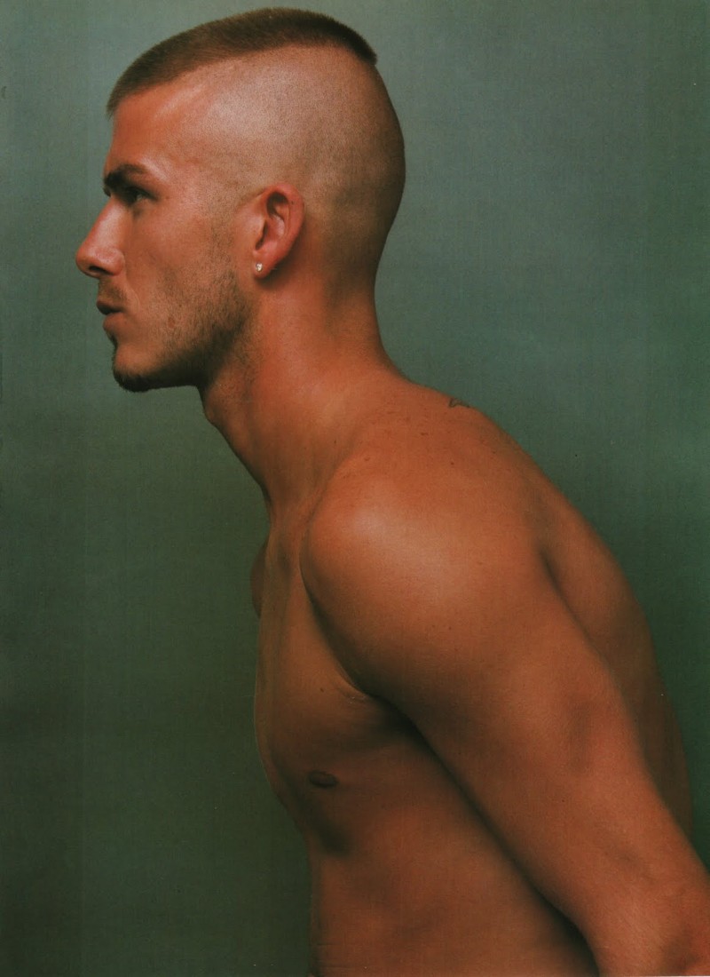 David Beckham photographed by Steven Klein for Arena Homme+ in 2000. Beckham sports a severe military style buzz cut.