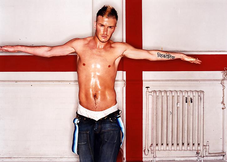 David Beckham photographed by David Lachapelle in 2002 for British GQ. Beckham sports a short blond mohawk.