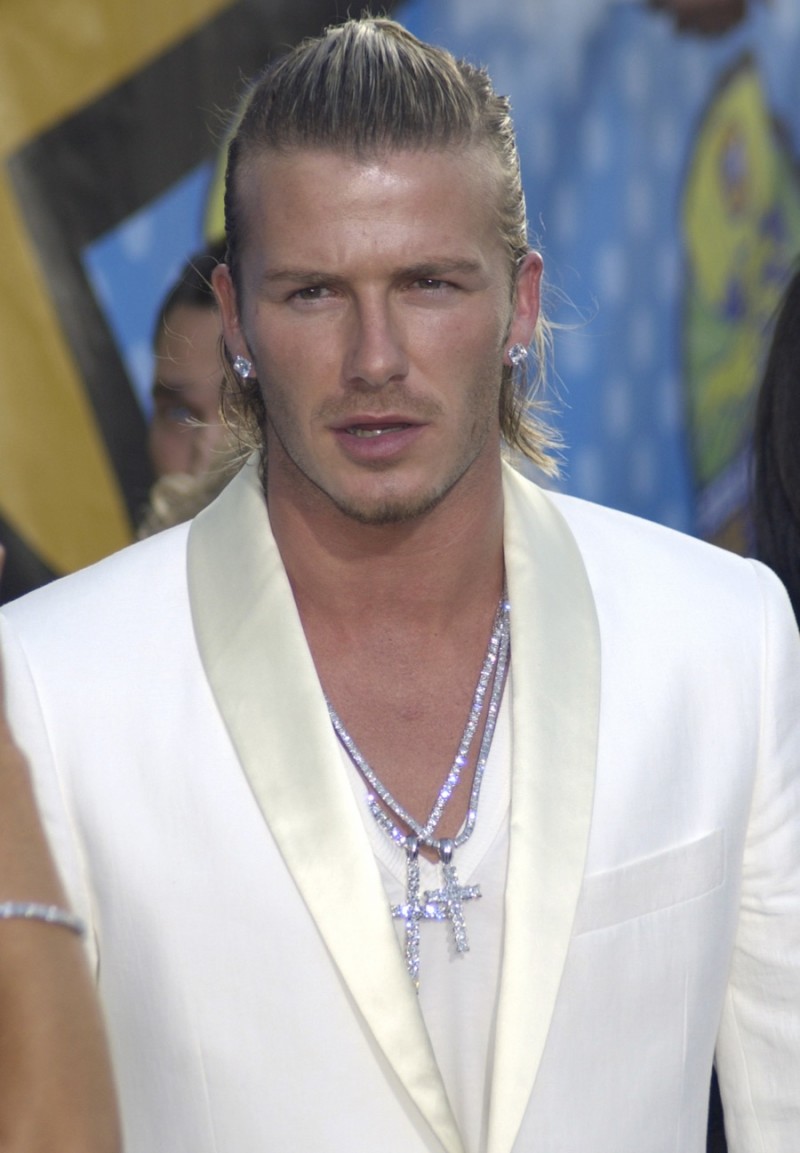 Sporting a longer, blond hair style, David Beckham slicked his hair back into a half man bun. Image Credit: Shutterstock.com