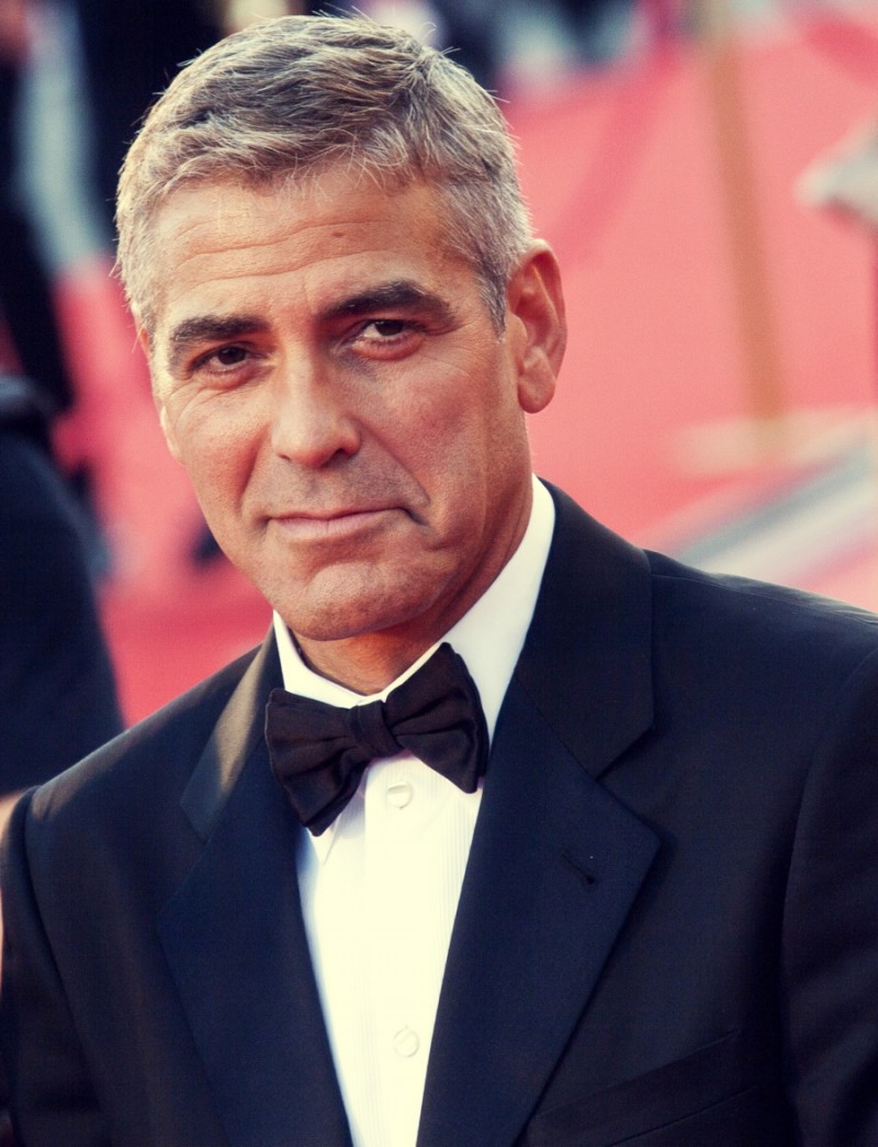 VENICE, ITALY - AUGUST 27: George Clooney greets fans as the arrives at the opening ceremony and 'Burn After Reading' Premiere during the 65th Venice Film Festival on August 27, 2008 in Venice, Italy. Photo Credit: Shutterstock.com