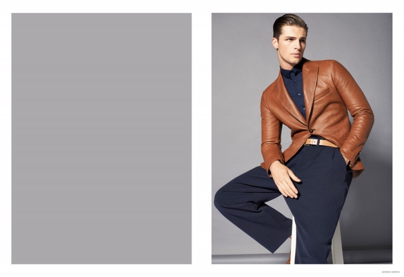 British model Edward Wilding cleans up in a rich brown leather blazer with wide-cut navy trousers from Giorgio Armani's spring-summer 2015 menswear collection.
