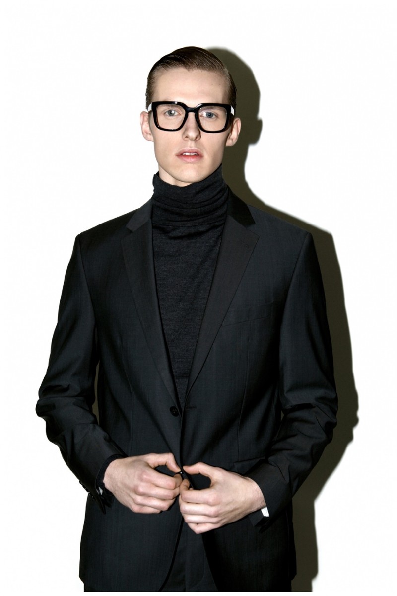 Jacob Okrasa channels Tom Ford's A Single Man in black frames and a sharp suit.