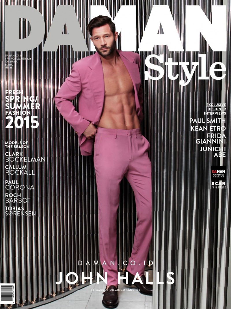 Wearing a colorful spring suit, John Halls is photographed by Marcos Domingo Sanchez for the cover of Da Man Style.