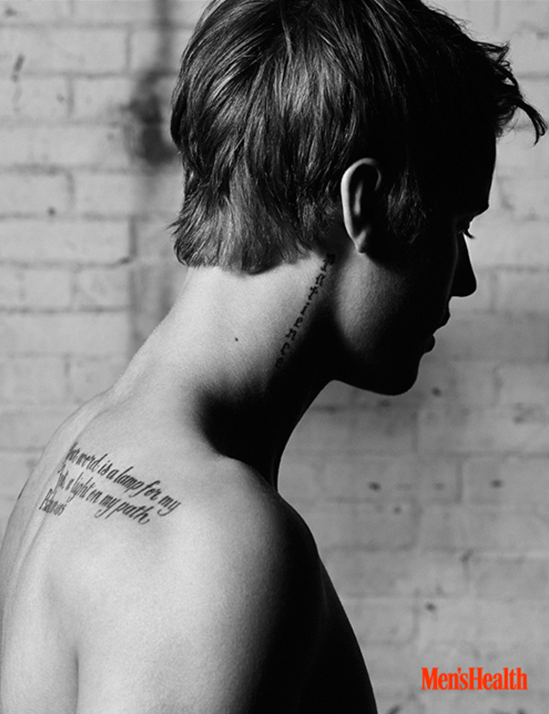 A side angle captures several of Justin Bieber's tattoos. » Justin Bieber Goes Shirtless for Men's Health April 2015 Cover Shoot, Talks Maturing + Hitting the Gym A side angle captures several of Justin Bieber's tattoos.