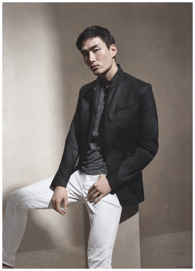 Model Noma Han models a chic black and white look pairing a modern blazer with white jeans.