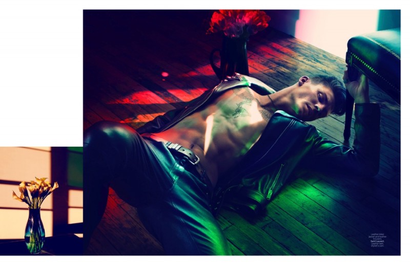 Laying on the floor, Mikkel Jensen is clad in leather.