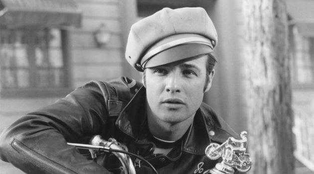 In one of his most iconic roles and photos, Marlon Brando poses in character as bad boy Johnny Strabler in "The Wild One." He sports his trademark leather biker jacket, jeans, and biker cap.