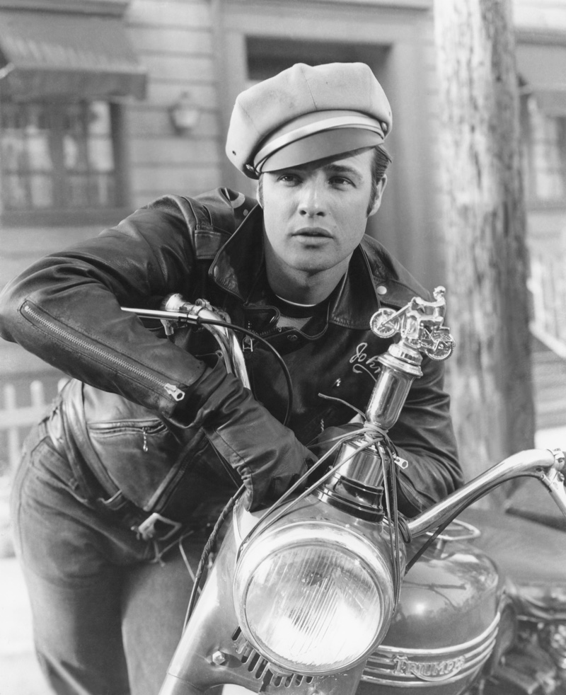 In one of his most iconic roles and photos, Marlon Brando poses in character as bad boy Johnny Strabler in "The Wild One." He sports his trademark leather biker jacket, jeans, and biker cap.