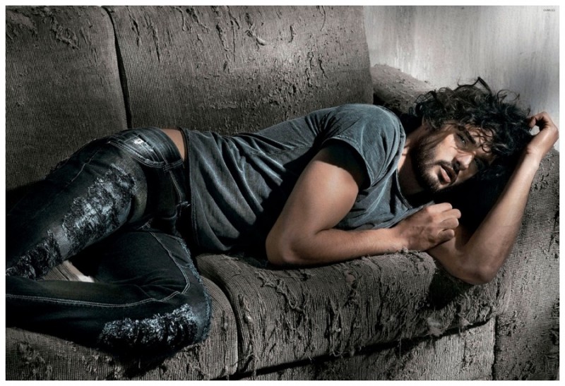 Captured on an old beat couch, Marlon Teixeira wears a destroyed t-shirt style.