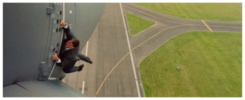 No stranger to danger, Tom Cruise hangs onto the outside of an airplane.