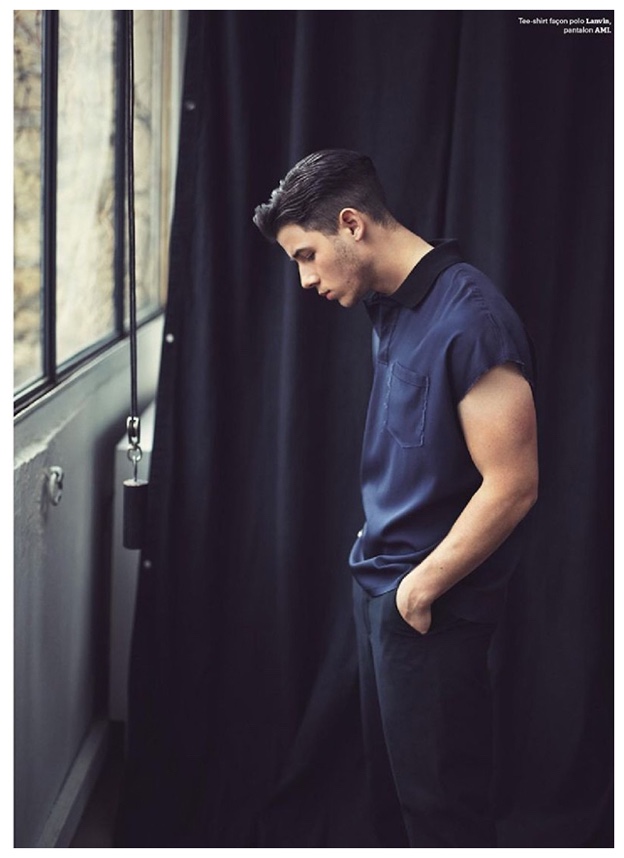 Posing for a moody image, Nick Jonas wears a Lanvin polo with AMI pants.