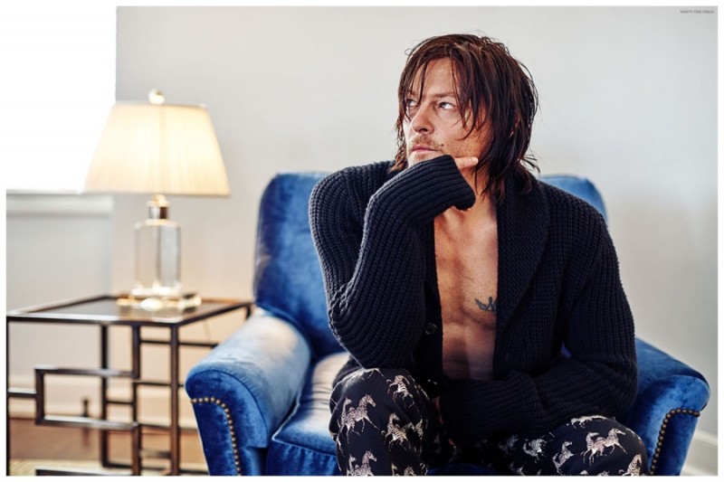 Norman Reedus relaxes in a an oversized shawl neck cardigan sweater with zebra print pants.