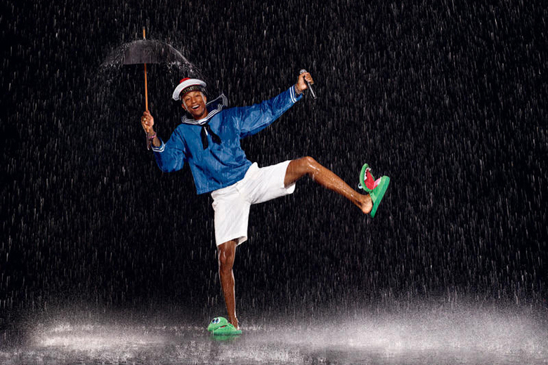 Pharrell dances in the rain.