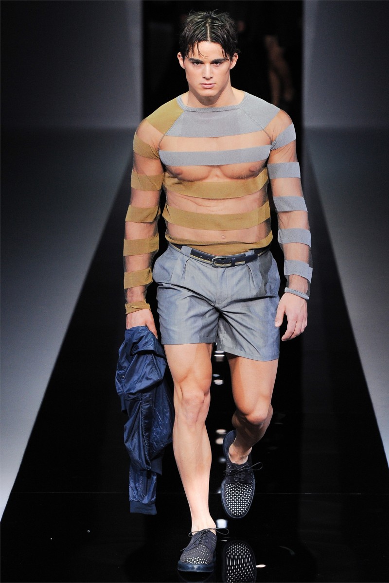Wearing a striped sheer top, Pietro Boselli walks for Emporio Armani's spring-summer 2013 show.