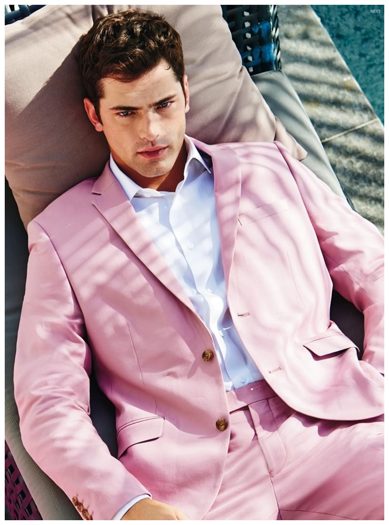 Embracing the season, Sean O'Pry lounges outdoors in spring hued suit.