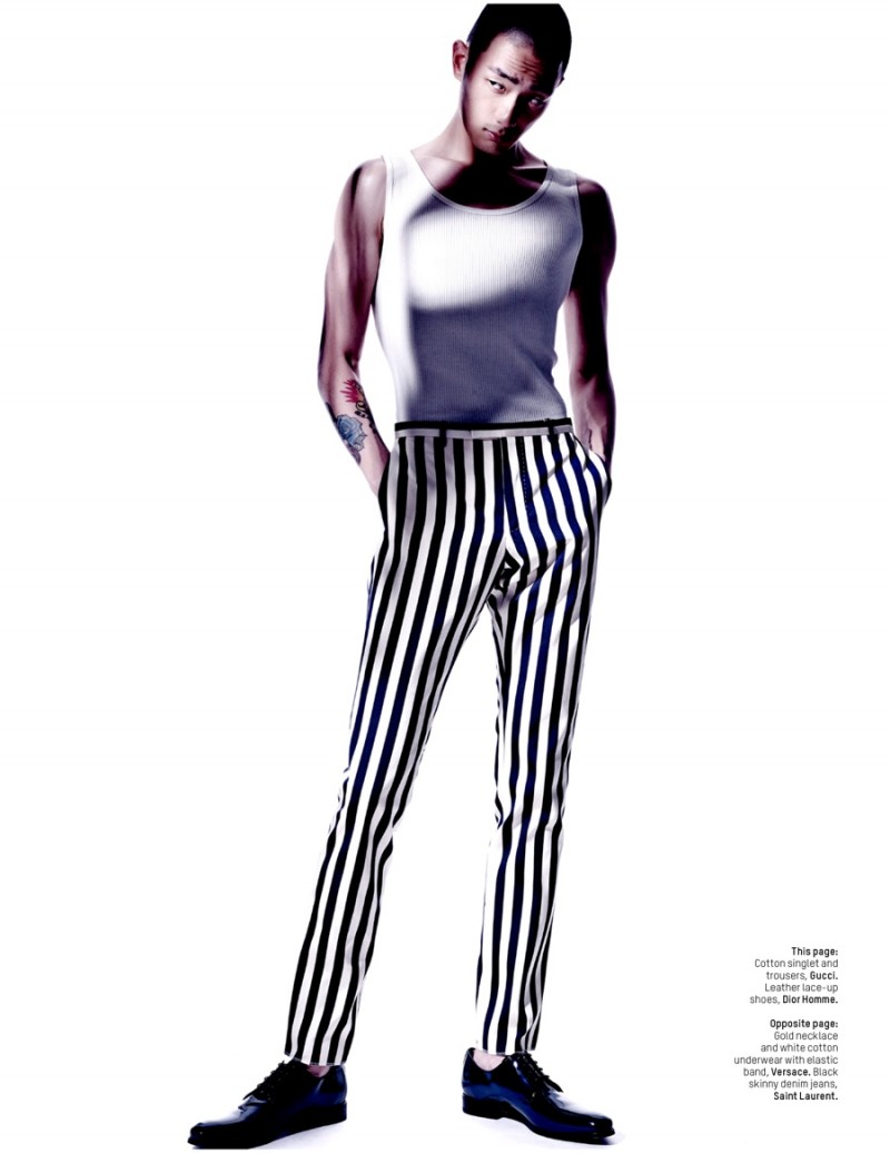 Sung Jin Park stands tall in black and white striped Gucci trousers.
