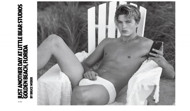 Model Jordan Barrett poses in a white swimsuit for the pages of VMAN.