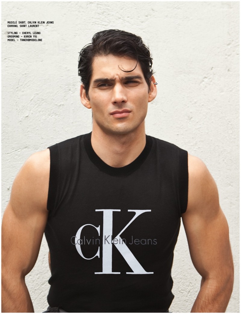 Taner rocks a Calvin Klein Jeans muscle tee.