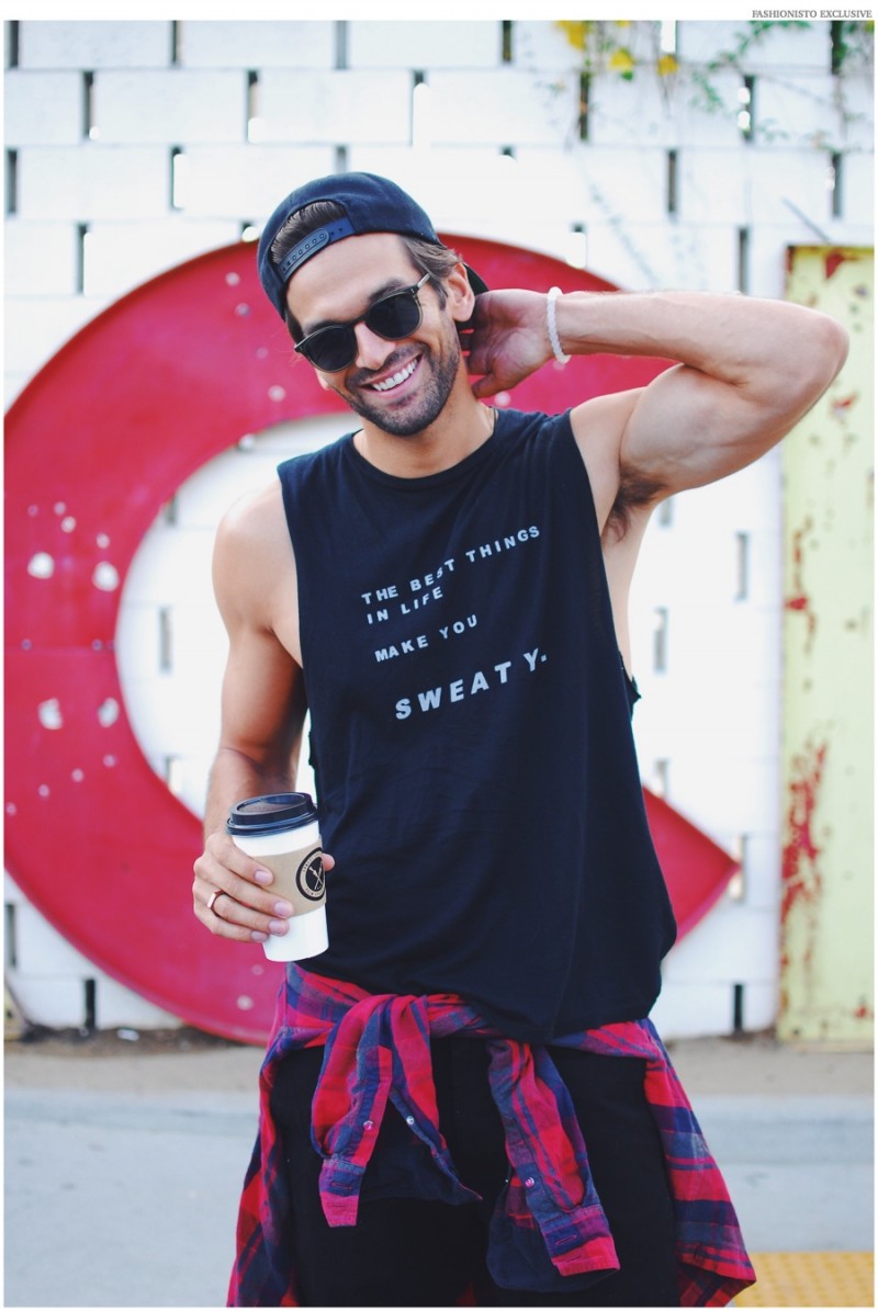 Colin wears shirt GoodhYOUman, bracelet Lokai, flannel shirt Ben Sherman, jeans AG Jeans and sunglasses Garrett Leight.