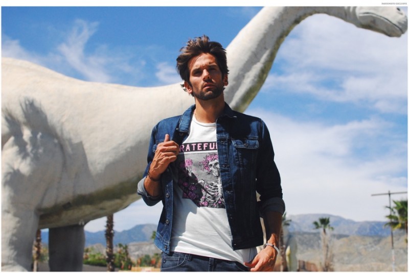 Colin wears graphic t-shirt Junk Food, denim jacket and jeans AG.