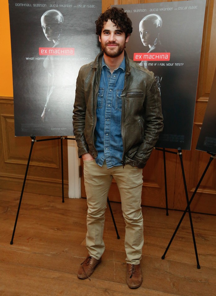 Attending the New York premiere of Ex Machina, Darren Criss goes for a classic denim and khaki pairing, finished with a brown leather jacket.
