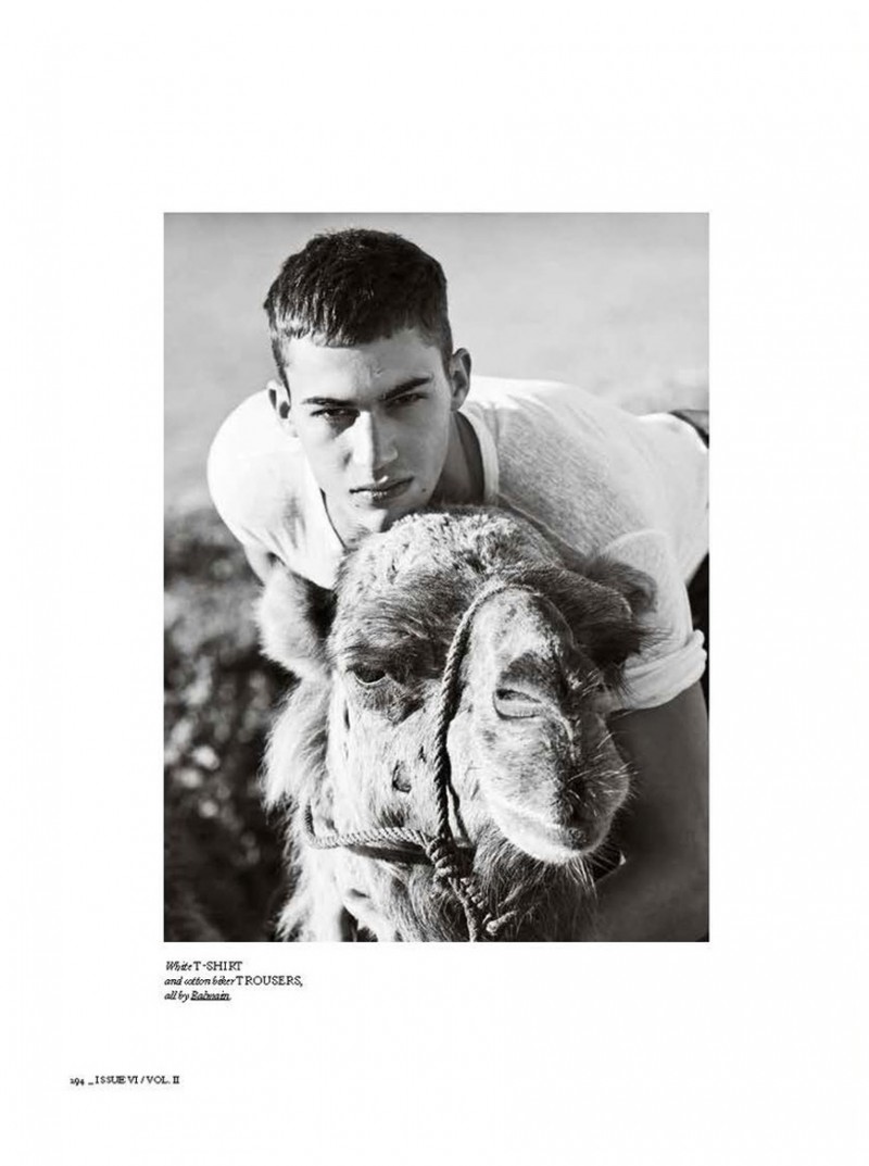 Alessio Pozzi poses with a camel in a Balmain t-shirt.