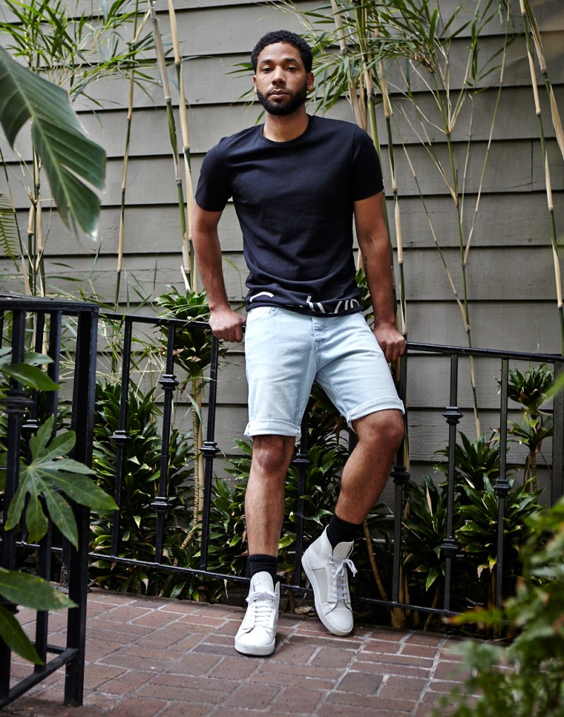 Jussie Smollett poses in his Calvin Klein denim shorts and logo t-shirt.