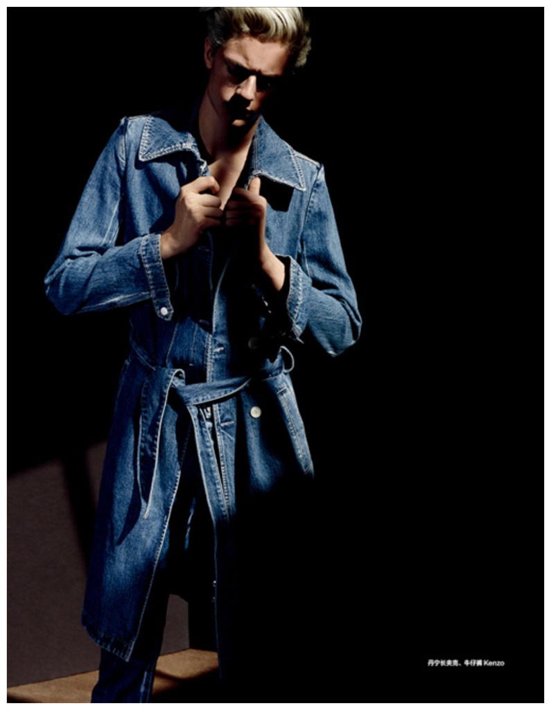 Lucky Blue Smith pictured in the shadows, rocking a denim coat from Kenzo.