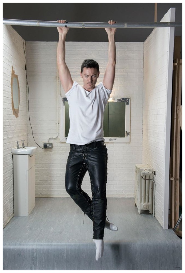 Luke Evans stretches in a daring pair of leather pants.