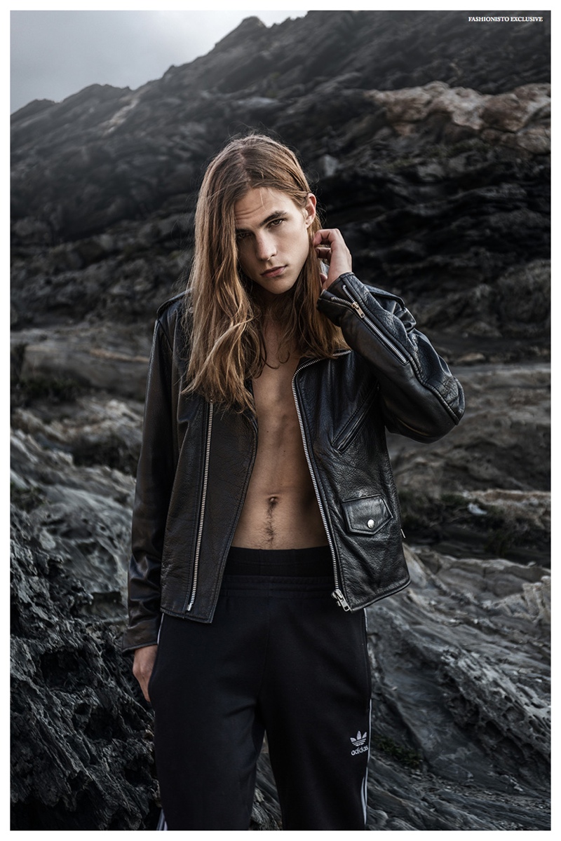 Malcolm wears leather biker jacket Diesel and joggers Adidas Originals.