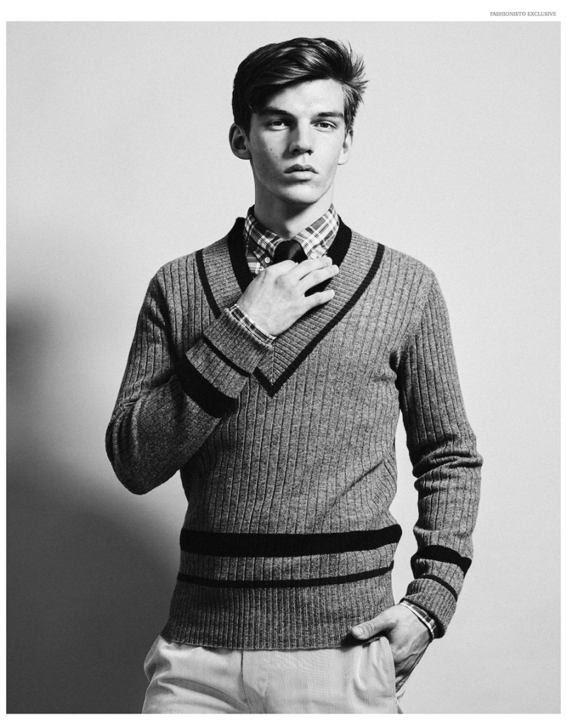 Wearing a v-neck sweater with a shirt and tie, Miles Hurley is the preppy boy next door.