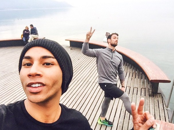 Wearing a knit beanie, Olivier Rousteing  poses for a selfie with his trainer.