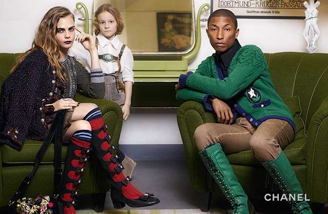 Joined by Cara Delevingne and Hudson Kroenig, Pharrell goes bold in green knee-length boots and a cardigan.